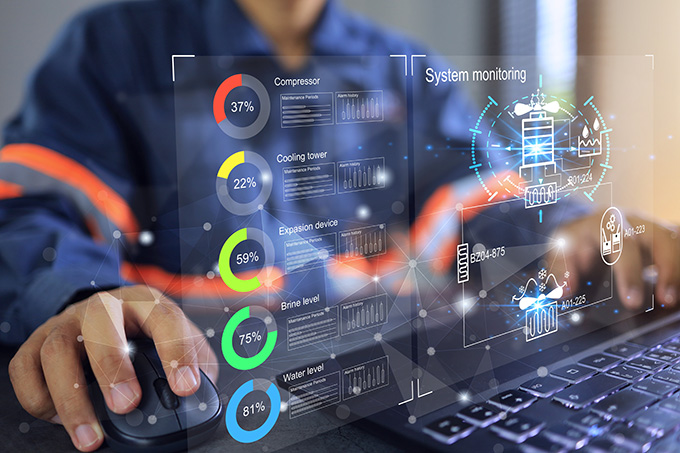 a man working on a laptop looking at a heads up display