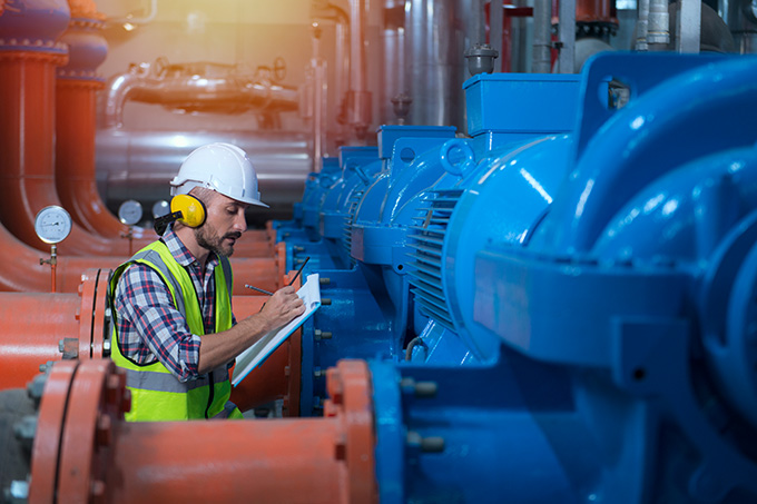 an engineer servicing a large piece of machinery