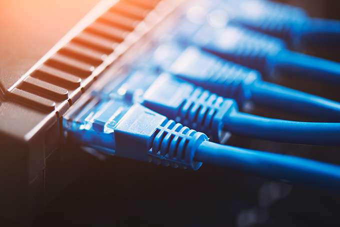 A blue ethernet cable is connected to a computer.