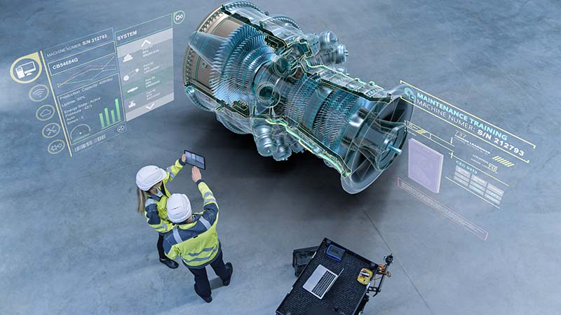 engineers inspecting data for a piece of machinery