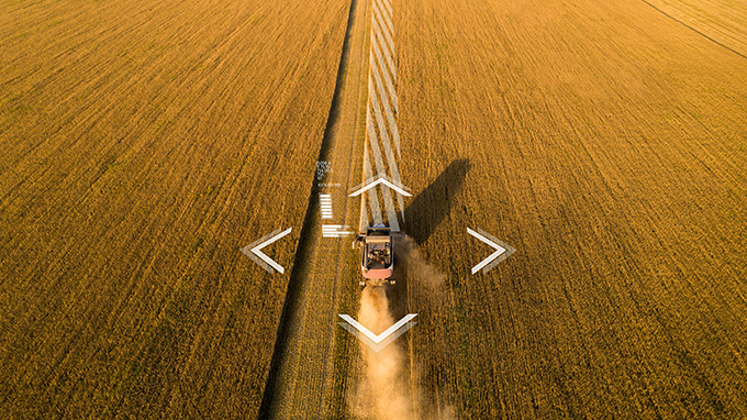 smart tractor harvesting a crop and sending data to the cloud